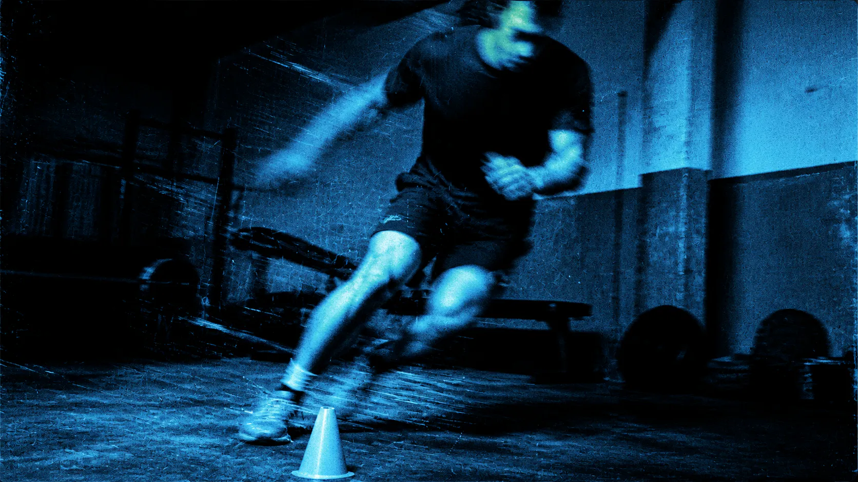 An athlete moving through a shuttle run in a neighborhood gym